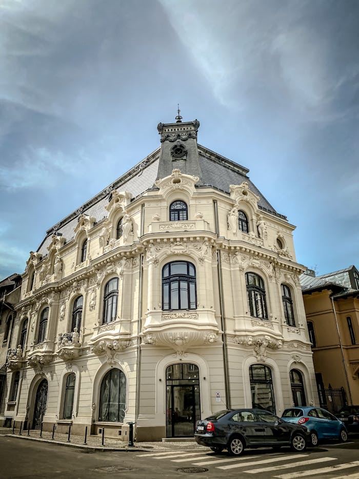 Elegant historical building with ornate facade in Bucharest on a cloudy day.